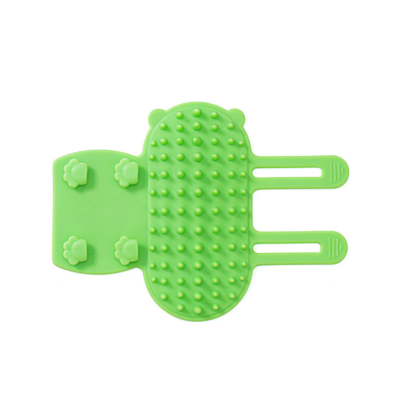 Green silicone self-grooming cat brush with rounded bristles and adjustable straps for gentle grooming and loose fur removal