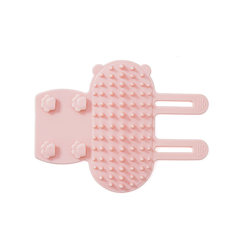 Pink silicone self-grooming cat brush with rounded bristles and adjustable straps for gentle grooming and loose fur removal