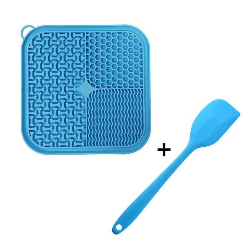 Blue silicone slow feeder lick mat with textured sections and spatula for spreading treats and soft pet food